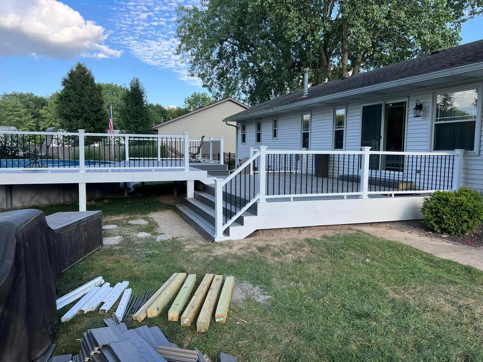 Brand new white deck with black metal railings