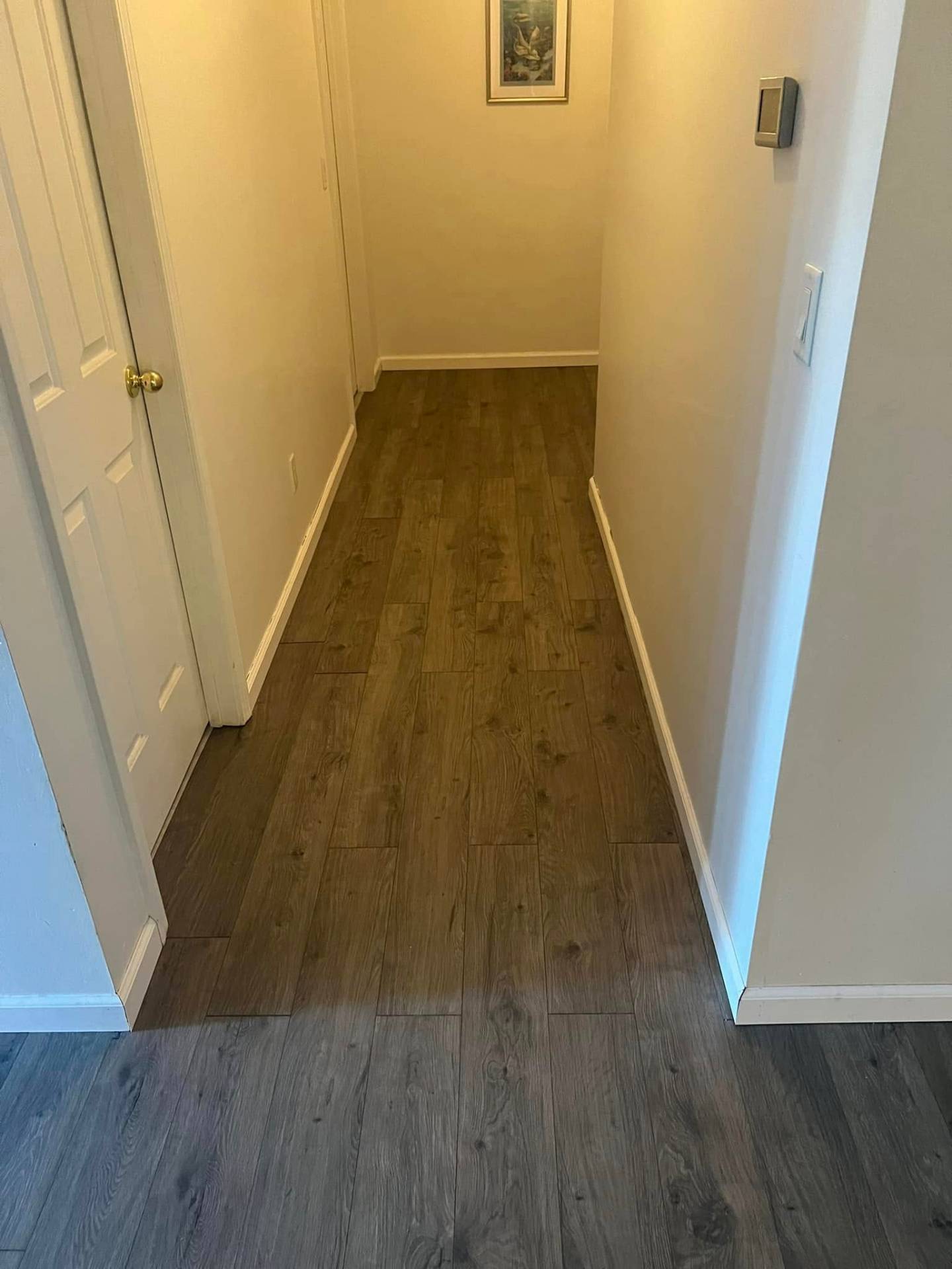 New dark wood plank flooring in hallway