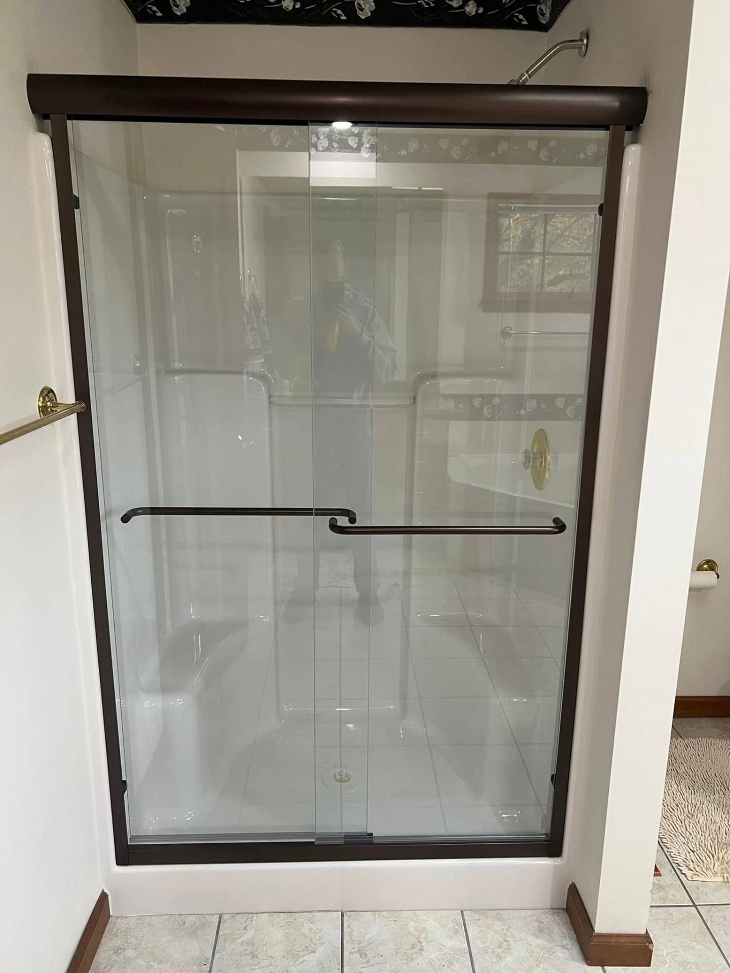 New glass sliding shower door with dark bronze frame