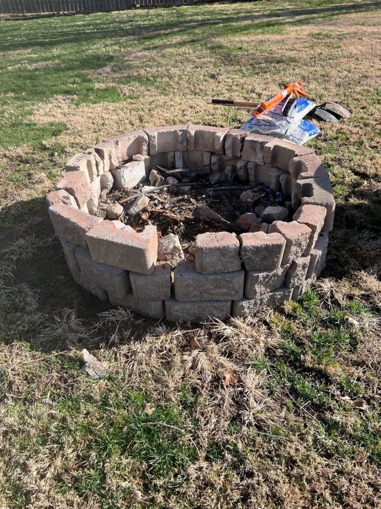 Old broken fire pit with debris before rebuild